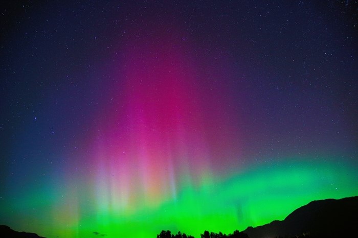 Neon northern lights in starry sky over Chilliwack. 