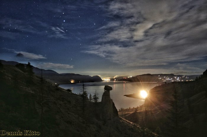 Coyote Rock in Savona is captured at night with a train in the background. 