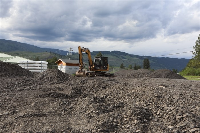 A stationed excavator at the site of the stockpile of RAP, stored nearby the community pow wow arbour and water treatment facility, on May 15. Photo by 