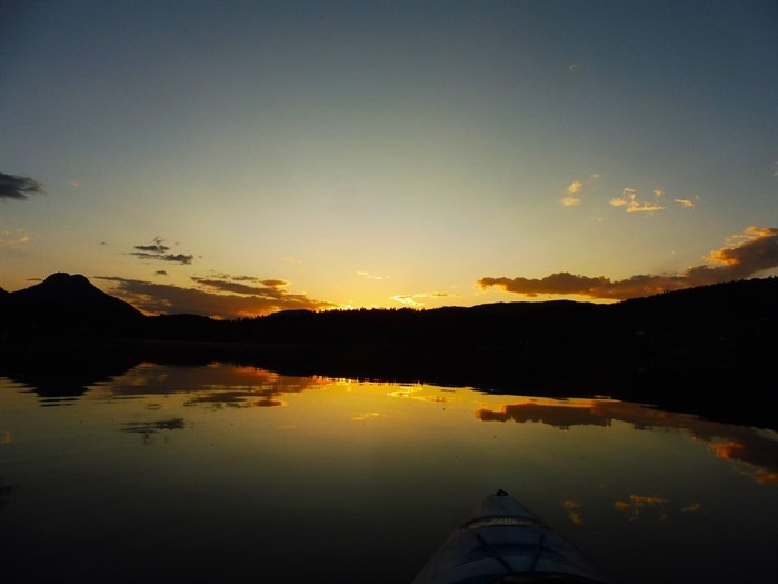 A paddleboarder captures the sun setting over Pinantan Lake near Kamloops. 