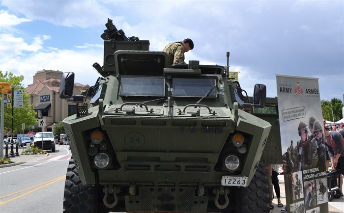 A soldier poking out the hatch of a military vehicle on Canada Day 2024.