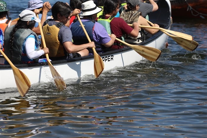 syilx Okanagan community members paddle on nk’mip (Osoyoos Lake) in sw?iw?s (Osoyoos) for the 2024 Suk?naqin canoe journey. 