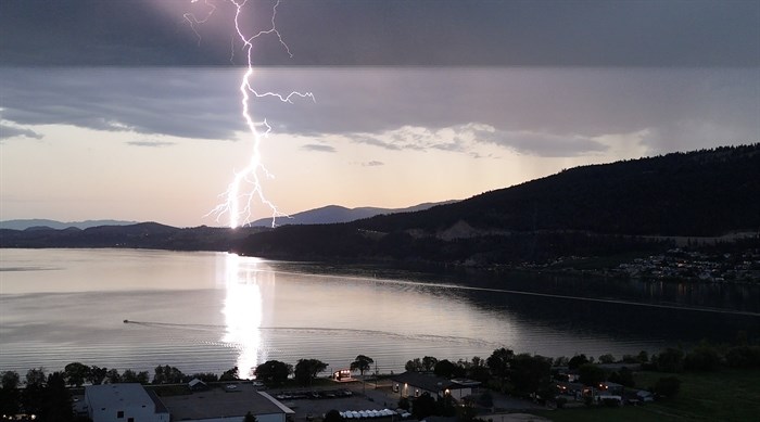 A lightning storm brightens the dusky sky in Oyama. 