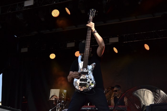 Josh Paul from Daughtry hoisting a shiny bass guitar at Rock the Lake on July 13, 2024. 