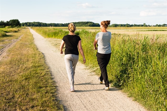 Two women walking on a path