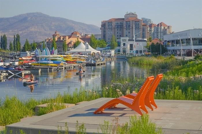 Paddle boarders drift along the Kelowna waterfront on an early summer morning. 