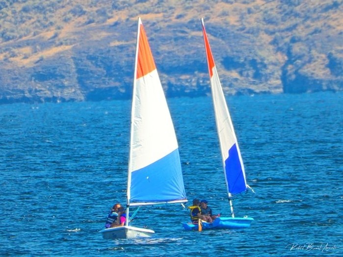 Sailboats cruise along the Okanagan Lake in Summerland. 