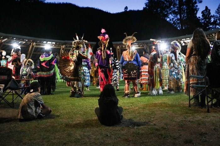 Youth watch dancers participate in the grand entry for the 2024 Similkameen Powwow of Champions during its opening night on Aug. 30.