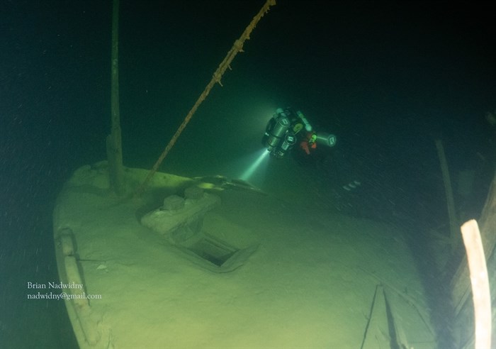 A diver exploring the wreck of the S.S. City of Ainsworth more than 100 metres below the surface of Kootenay Lake. 