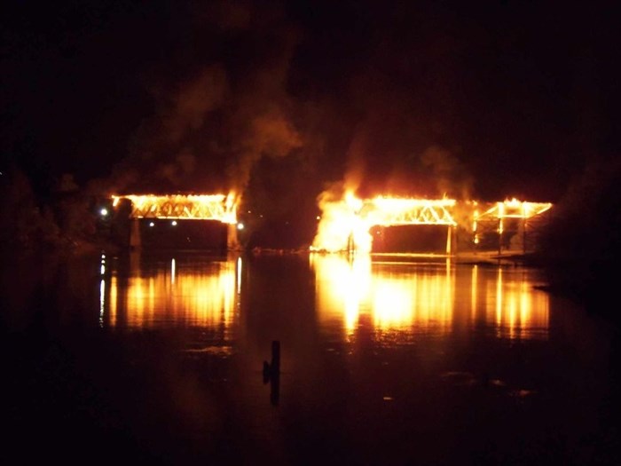 The bridge is seen fully engulfed after the first of three spans fell early Thursday morning, Sept. 19, 2024.