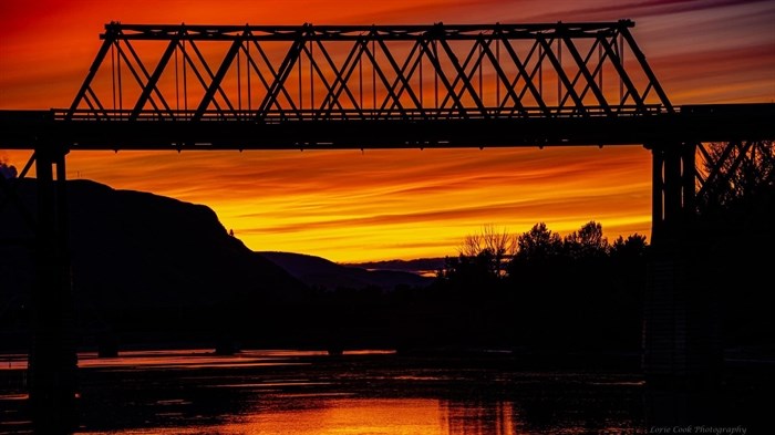 The Red Bridge in Kamloops is a silhouette in front of a sunset in 2023. 