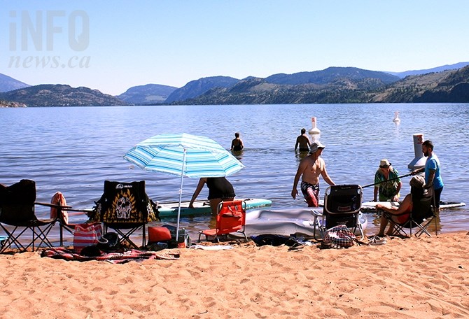 Beachgoers take to stand up paddleboards Monday afternoon at Sudbury Beach.