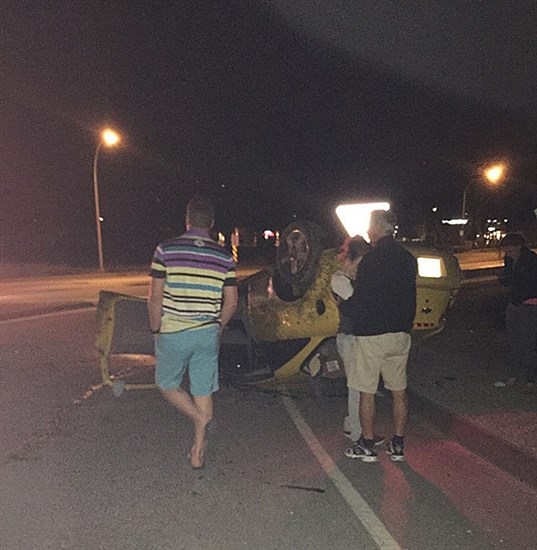 A car flipped on Highway 97 near the intesection of West Bench Drive early Tuesday morning, June 16, 2015.