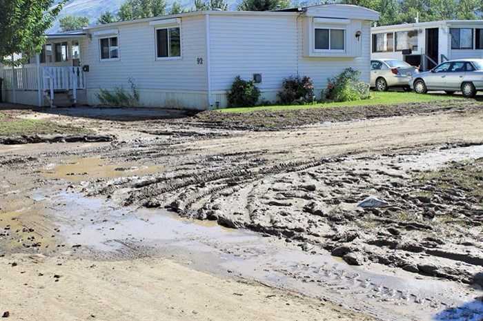 Some roads in the park are now caked in sludge while crews work to clean it up so residents can come back home.