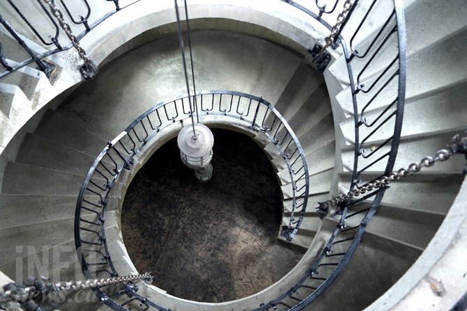 A three-storey spiral staircase leads to a rooftop patio that overlooks the entire property.