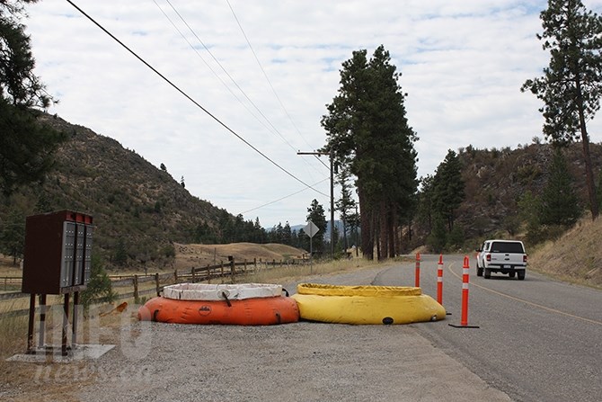 Porta tanks are staged on the Willowbrook Road July 23 as crews continue to work the Willowbrook fire, which broke out Monday, July 20.