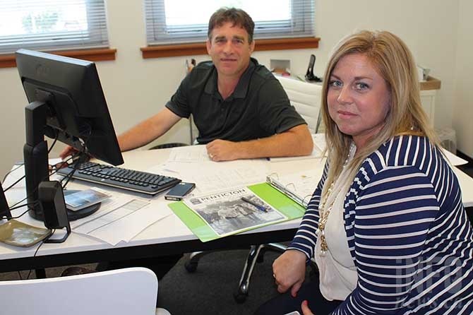 Former Tourism Penticton Executive Director Chris Bower, left, hands over the reins to the organization's new Director Kelly Hopkins on Monday, August 10, 2015.