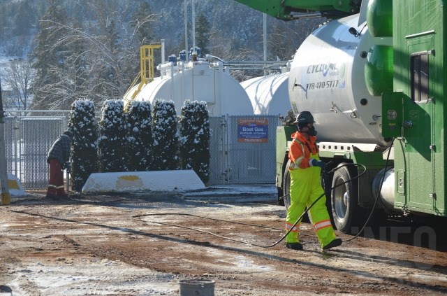 Clean-up crews mop up a fuel spill at the Centex Gas Station in Coldstream Nov. 25, 2015. 