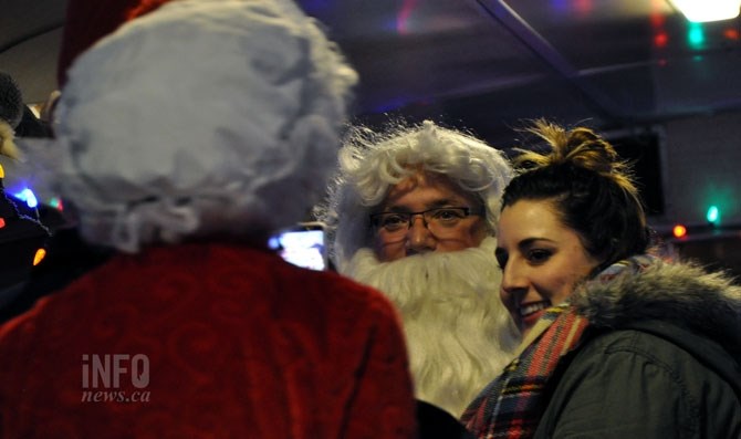 Santa and Mrs. Claus pose for pictures.