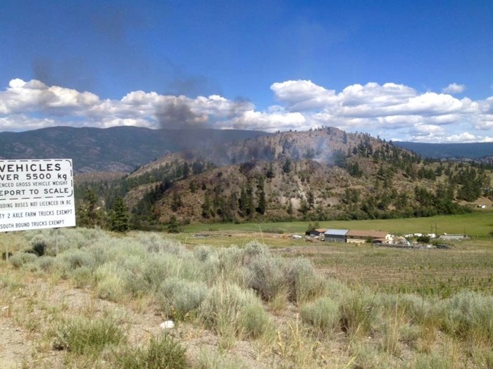 A brush fire in an old junkyard on a hill near Kaleden took about six hours to extinguish, Friday, June 18, 2016.