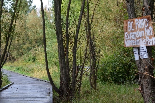 A sign seen on the BX Creek walking trail on Sept. 19, 2016, states 'B.C. road expansion not wanted in this park.' (FILE PHOTO)