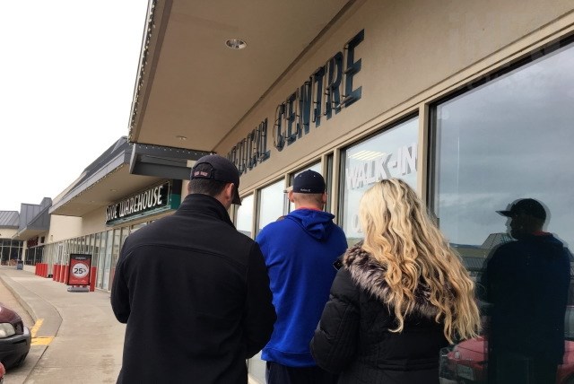 Patients stand in line, some of whom are trying to renew prescriptions for medical marijuana before the clinic closes. 