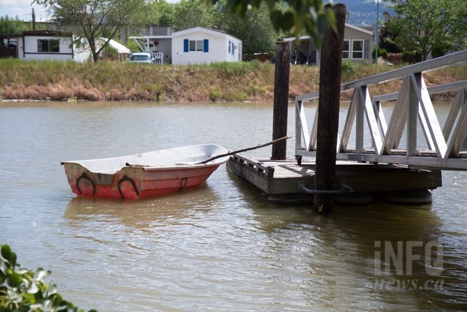 A rowboat floats beyond the closed pier at McArthur Island Park.