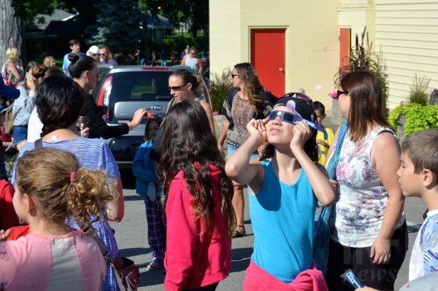 Jade Kelly, 11, takes in the solar eclipse at Polson Park. 