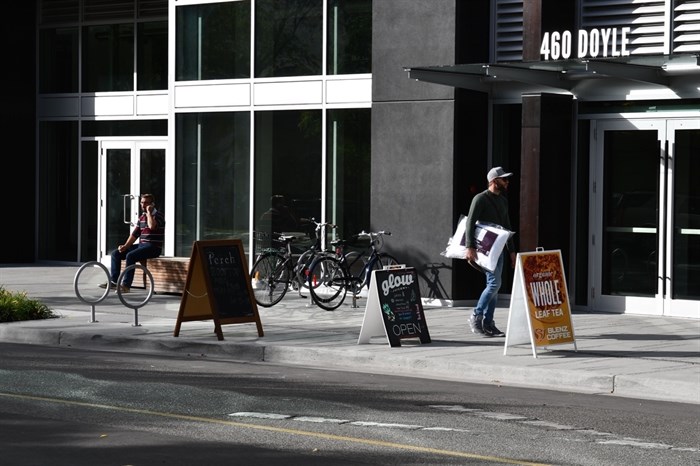 A pedestrian walks by the Okanagan Centre for Innovation on Doyle Avenue.