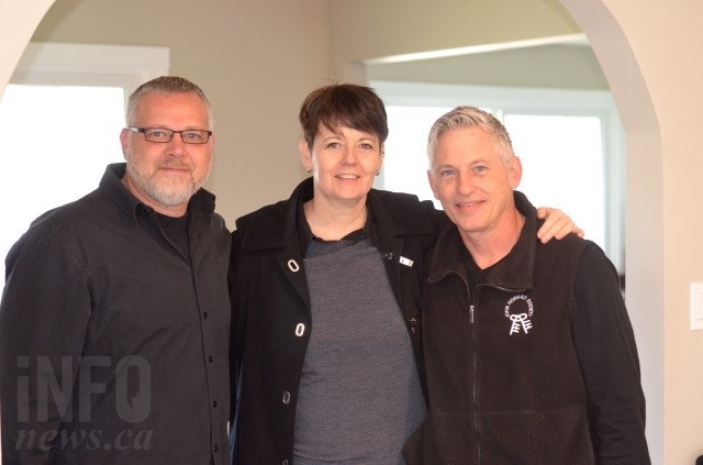 Kelly Fehr, Randene Wejr and Brad Houghton in the living room of the new sober living home. 