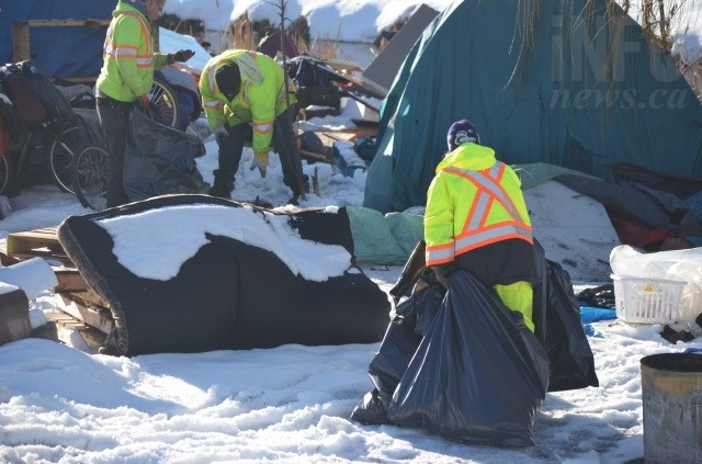 Contractors removed bikes, propane tanks, wooden pallets, and numerous personal effects from the camp today, Jan. 18, 2018. 