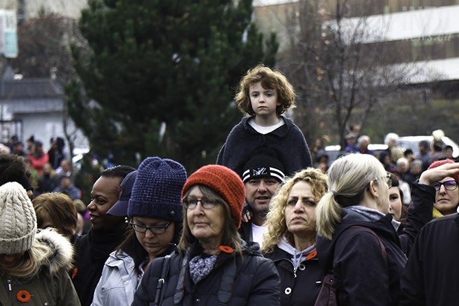 Daryl Snell lets his daughter Olivia Snell, age 6, sit on his shoulders so she can see above the crowd. 