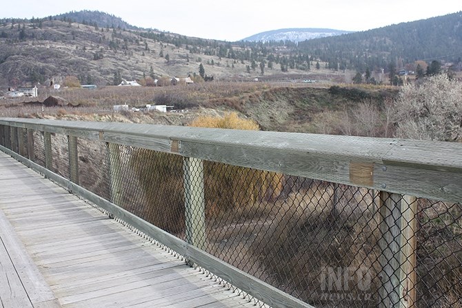 The destroyed plaques lined the railing of the trestle spanning Randolph Draw, their past presence indicated by the lighter shaded squares of wood along the top rail.