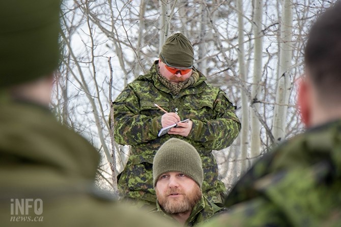 Capt. Michael Oviatt (top) writes notes as Lt. Max Birkner gives orders.