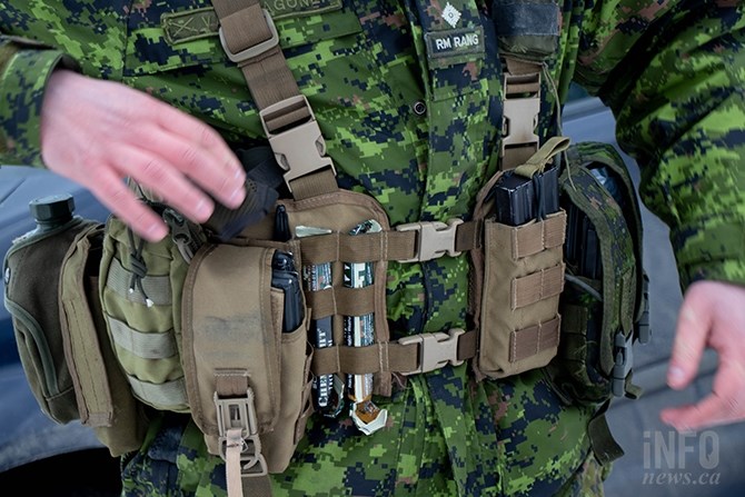 Capt. Kieran Van Wagoner shows off his utility belt that holds everything he will need to survive in the forest in case he has to ditch his rucksack. Glow sticks, radio, GPS, food, water, and a knife are just some of the things he keeps on him.