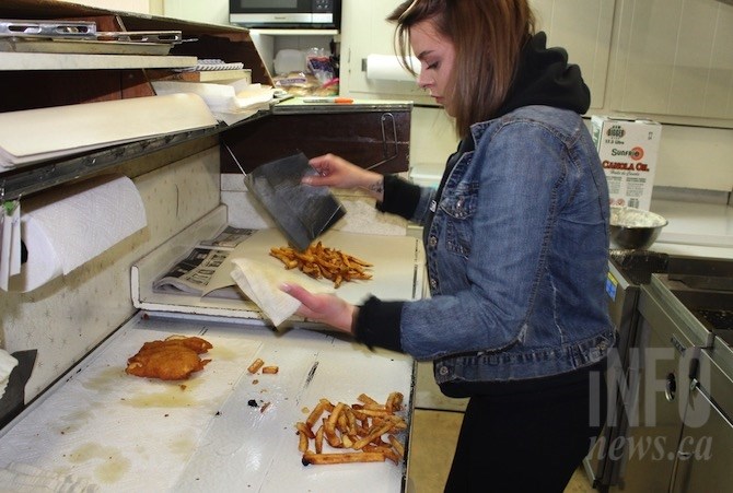 Sam Bell gets ready to wrap up the fish and chips