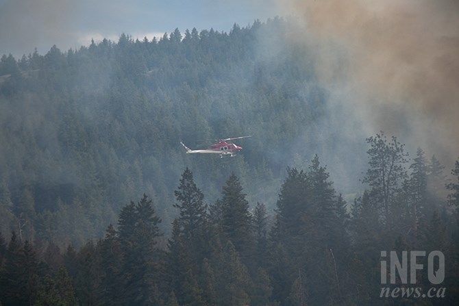 Another helicopter assisting with dousing efforts. 