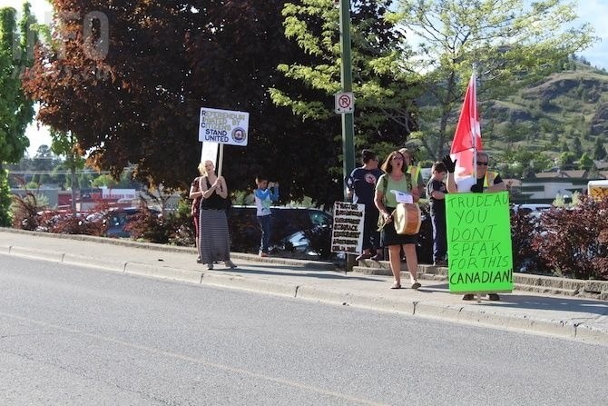 Roughly a dozen people gathered outside the venue where Justin Trudeau was set to acclaim Terry Lake as the Liberal candidate for the October federal election.