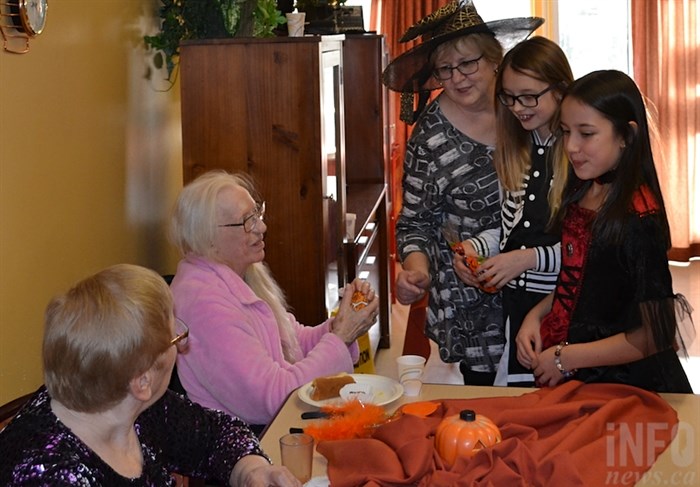 School friends Anika, left, and Jasmira attended Pine Grove's Halloween party for the first time this year.