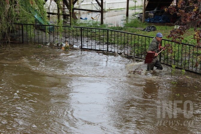 This man was wading in the creek trying to clear debris with a snow shovel, just below the Mill Creek bridge on Sutherland Avenue.