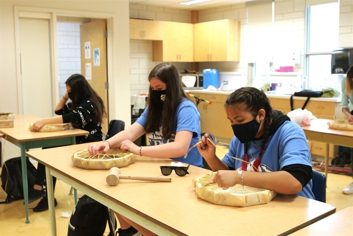 Klessen (left) and Louie (right) tie the skins onto their frames on May 12, 2021.