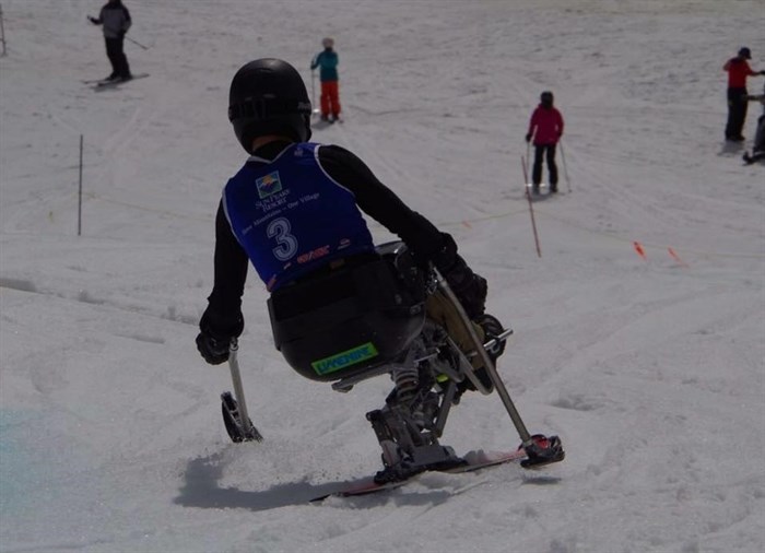 A skier on a sit ski at Sun Peaks. 