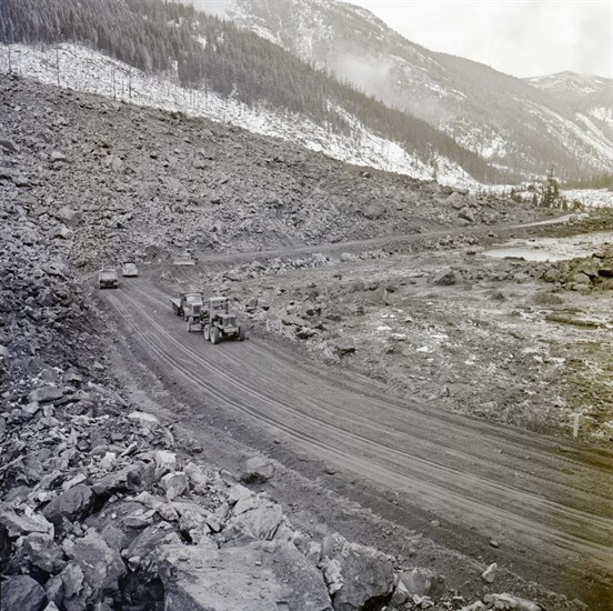 Construction equipment and crews working to build a new route, and re-open the highway.