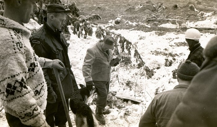 Former British Columbia Minister of Highways, Phil Gaglardi, with search and rescue canine, attended the scene to help assist with search and rescue efforts and to help direct the construction of a temporary road.