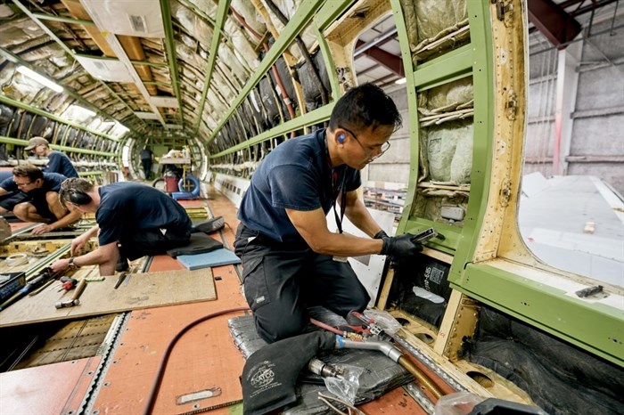 Workers at the KF Aerospace facility at Kelowna International Airport are seen in this undated photo.