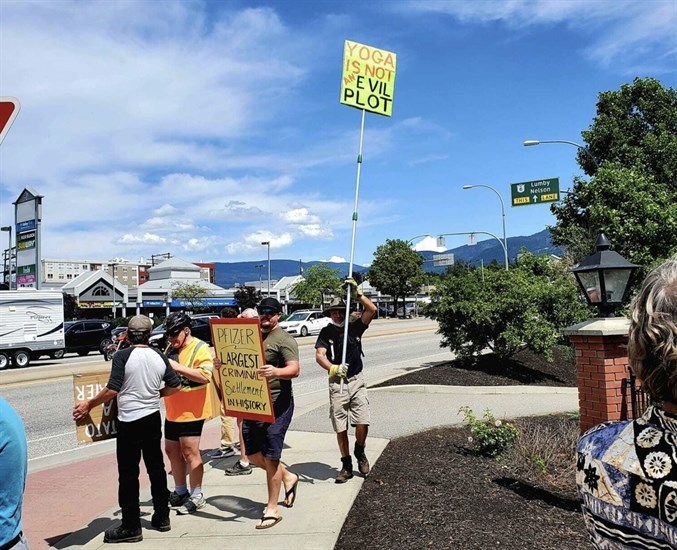 Korry Zepik stands with a sign outside of Polson Park, protesting the protestors, July 16, 2022.