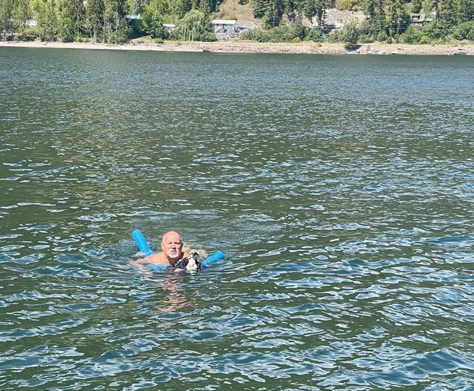 Salmon Arm resident Ed Parent bringing an injured osprey to safety. 