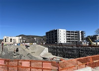 Hadgraft Wilson Place is visible on the right side of the photo, next to the UBCO construction site.