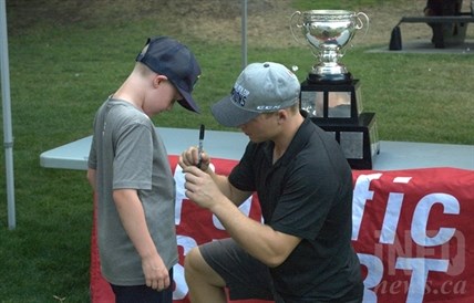 Kamloops native Joe Hicketts signs an autographs for 9-year-old Carter Johnson.